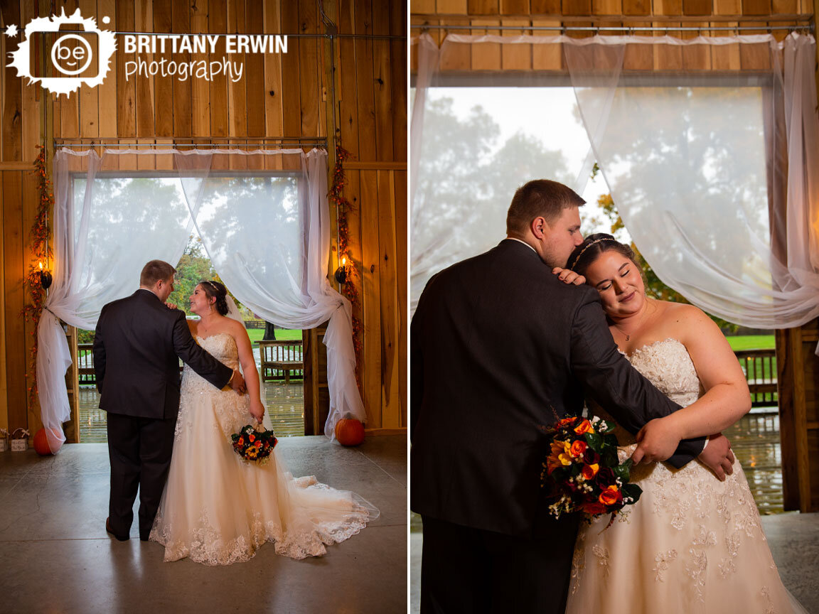 bride-and-groom-at-altar-doors-open-rainy-fall-day-snuggle.jpg