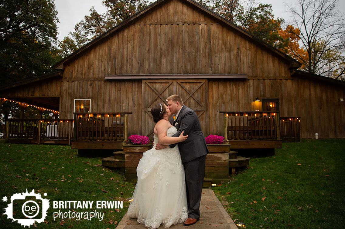 Barn-wedding-photographer-couple-in-front-of-venue-rainy-fall-day.jpg