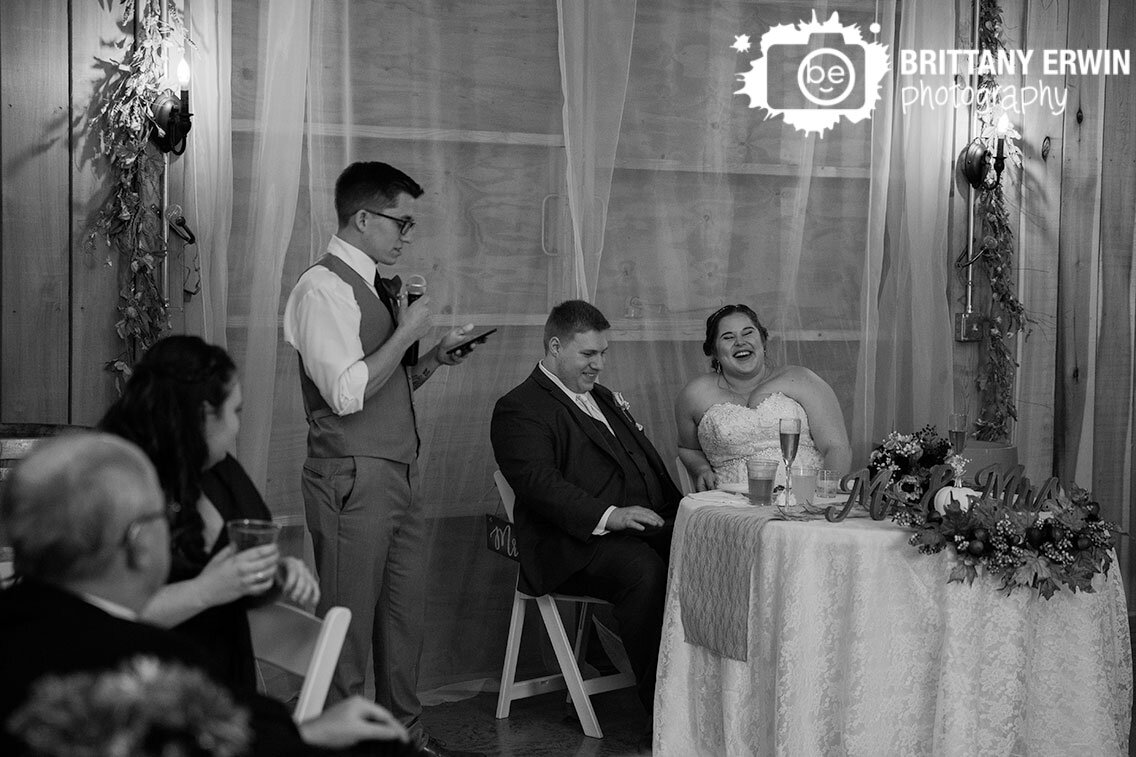 bride-laughing-toasts-speach-by-groomsman.jpg
