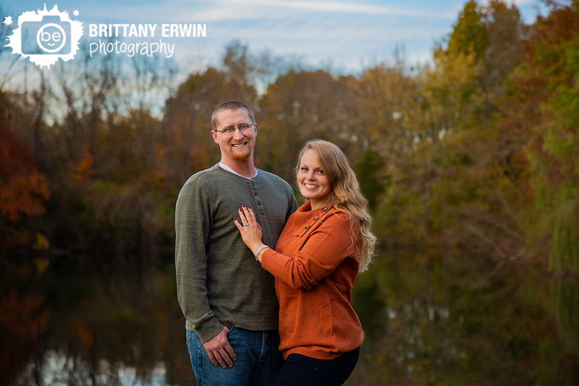 Indianapolis-engagement-fall-portrait-photographer-autumn-tones-leaves-trees-around-pond-couple.jpg