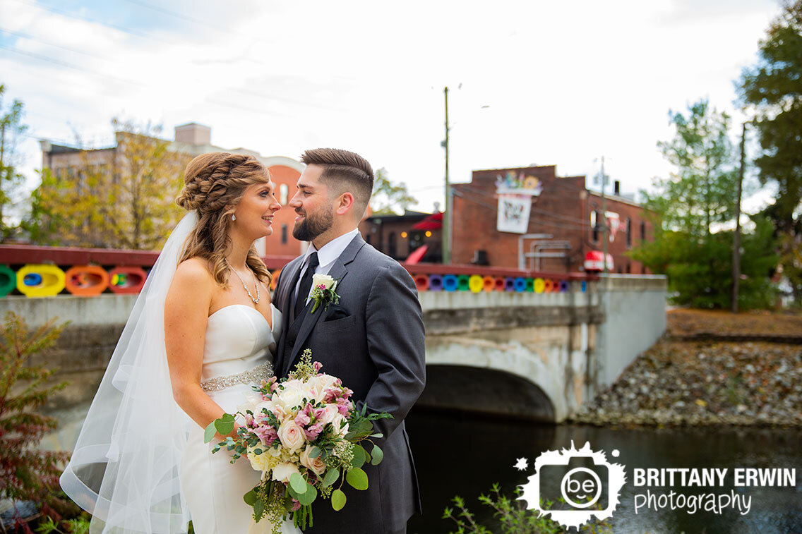 Broadripple-wedding-photographer-rainbow-bridge-couple-by-water.jpg