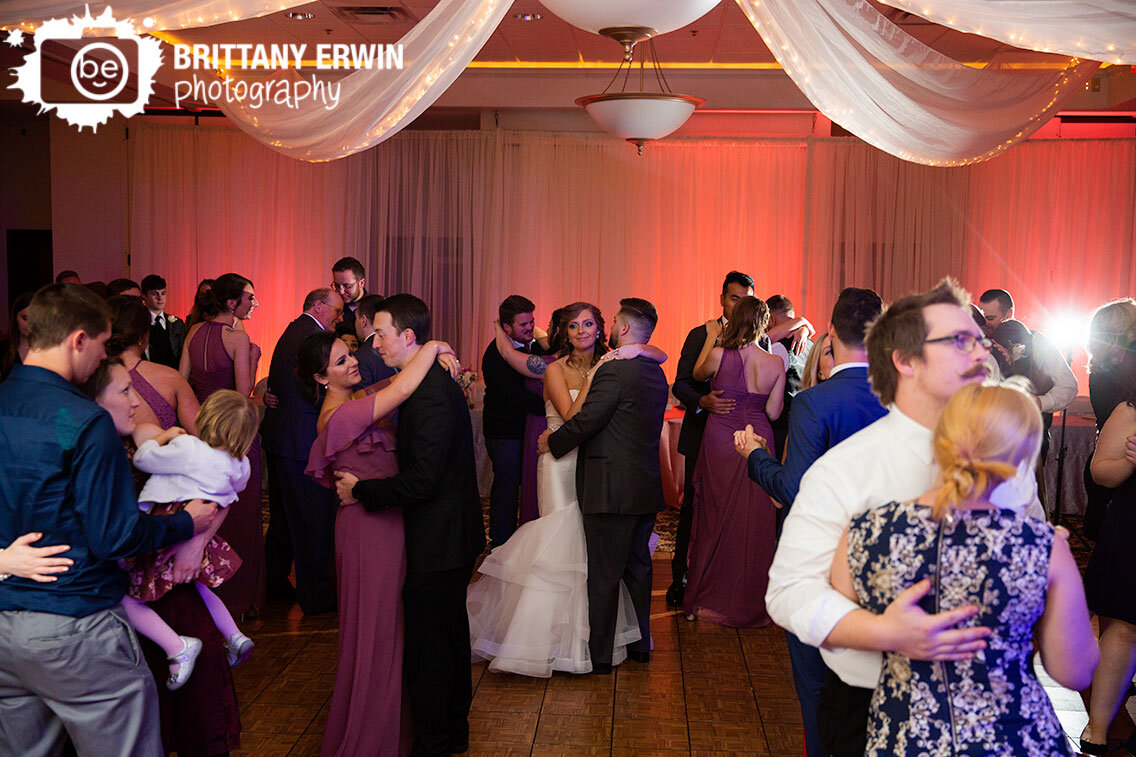 Indianapolis-wedding-photographer-the-wellington-reception-venue-couple-slow-dance-with-guests.jpg
