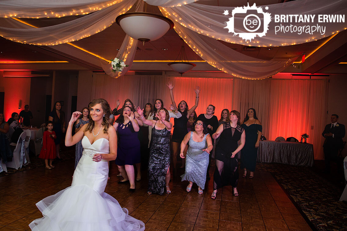bouquet-toss-at-the-wellington-indianapolis-wedding-venue-bride-with-midair-flowers.jpg