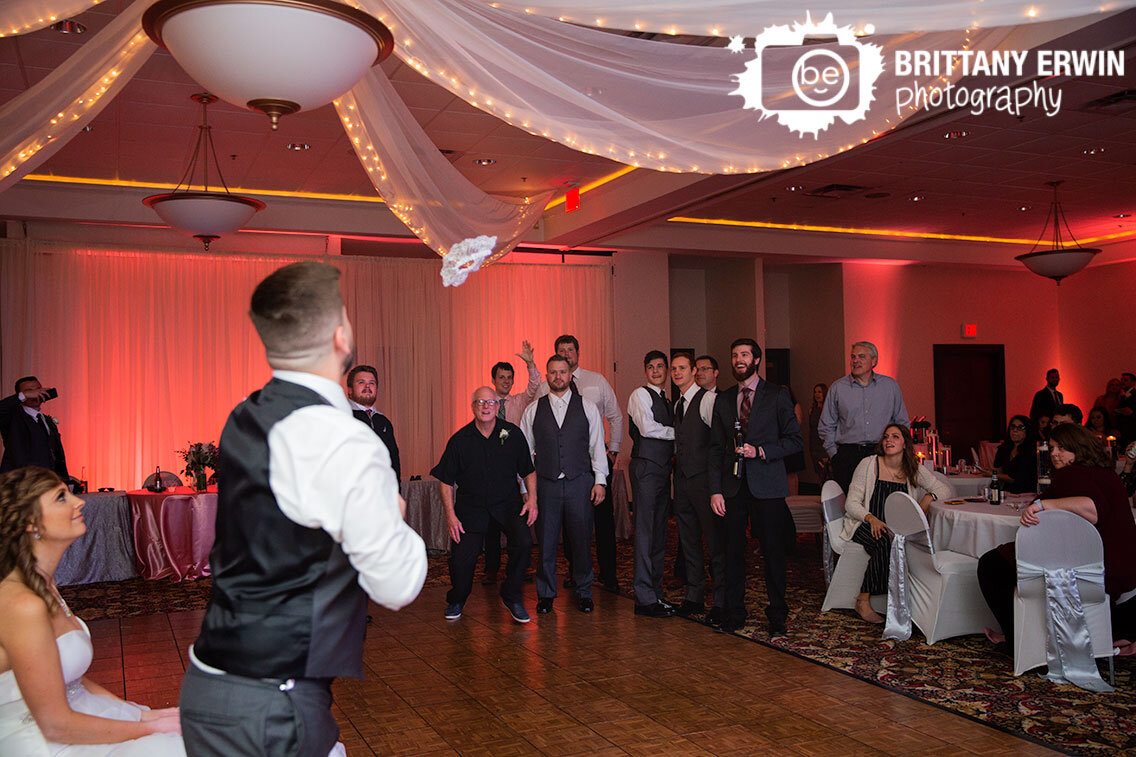 garter-toss-in-air-midair-the-wellington-wedding-reception.jpg