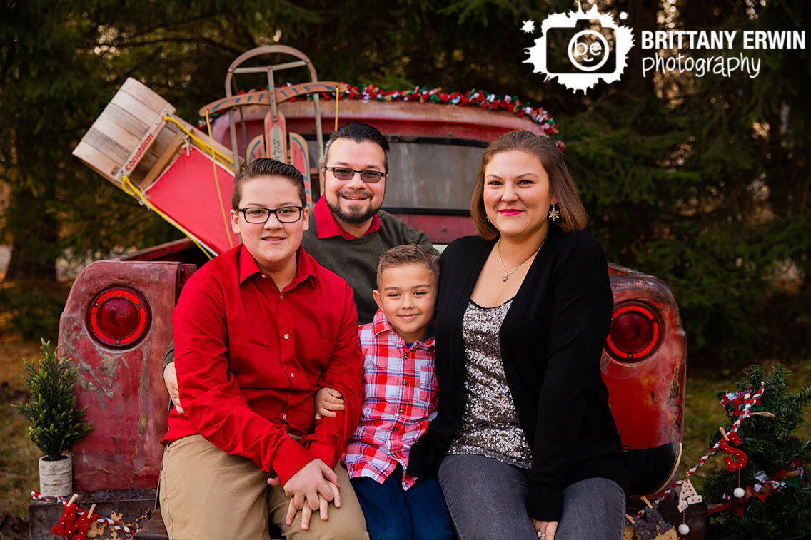 christmas-family-portrait-in-classic-red-truck-mini-session-photographer.jpg