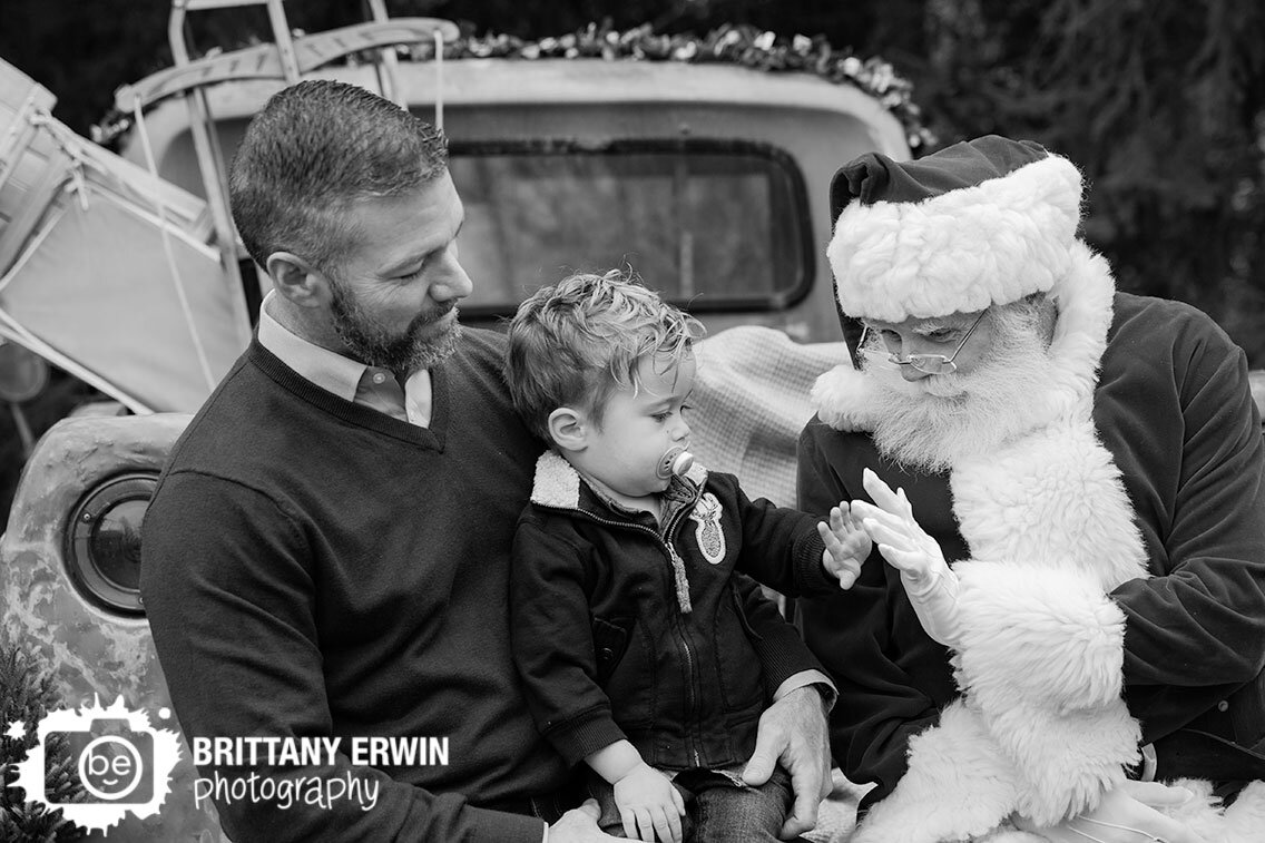toddler-boy-with-santa-high-five-sitting-in-classic-truck.jpg
