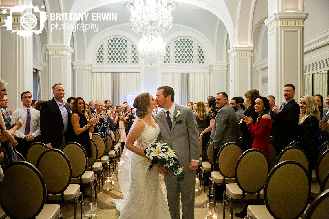 Omni-Severin-ballroom-wedding-ceremony-bride-groom-kiss-in-aisle.jpg