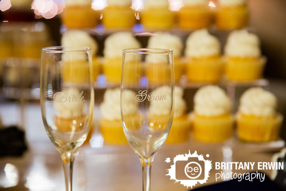 Indianapolis-bride-groom-toasting-flutes-with-cupcake-display.jpg