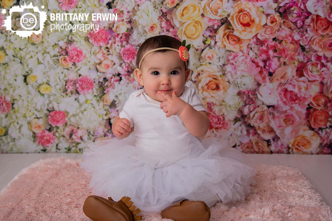 baby-girl-on-fuzzy-pink-rug-flower-floral-backdrop.jpg