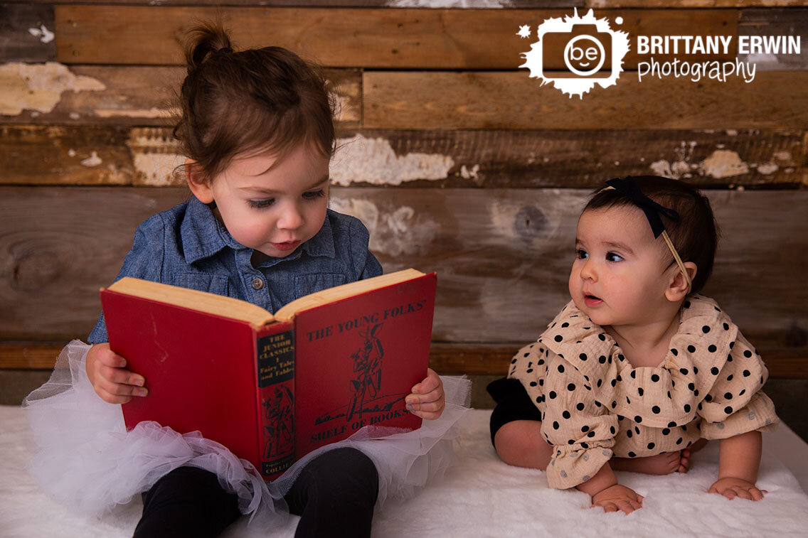 Siblings-sisters-sister-girl-reading-to-baby-portrait.jpg