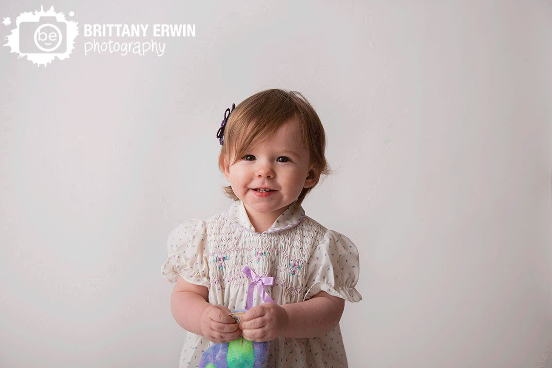 Indianapolis-portrait-photographer-toddler-girl-vintage-flower-dress-purple-bow.jpg