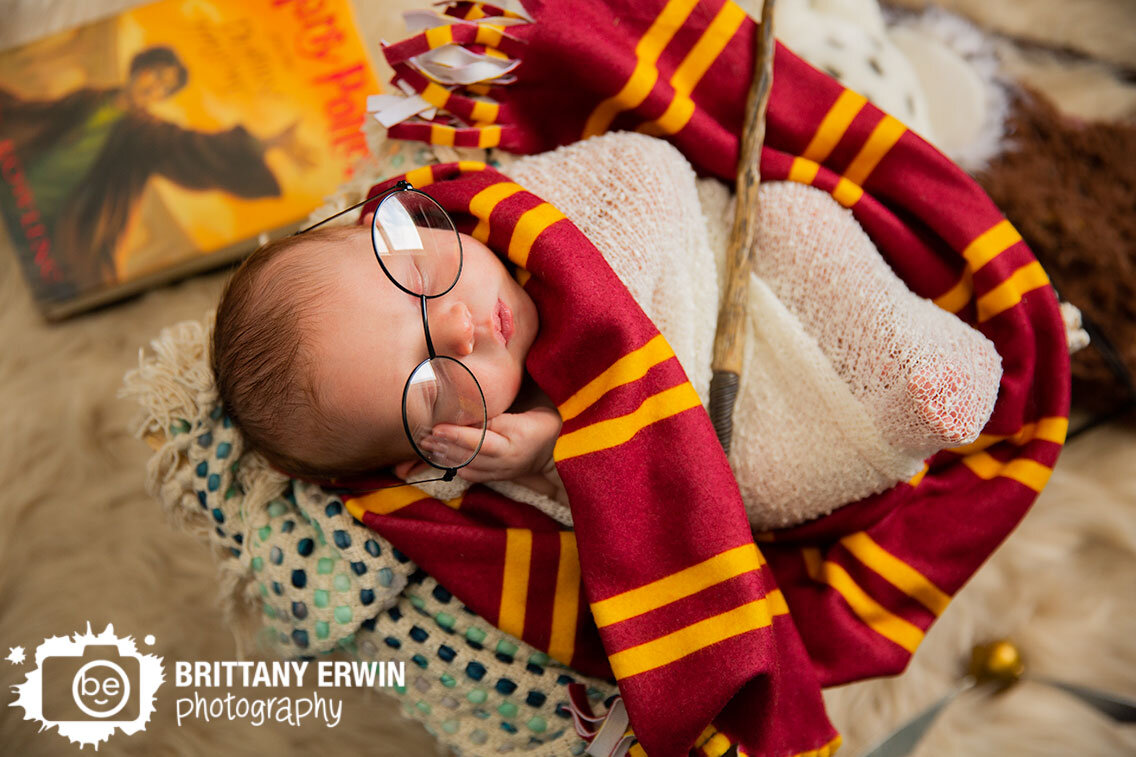 harry-potter-baby-boy-newborn-photographer-glasses-and-wand-sleeping-in-basket-with-griffindor-scarf.jpg