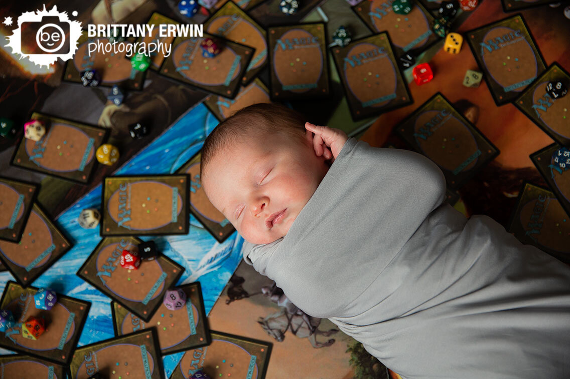 Magic-Cards-newborn-baby-boy-in-home-photographer-dice-on-game-mat.jpg