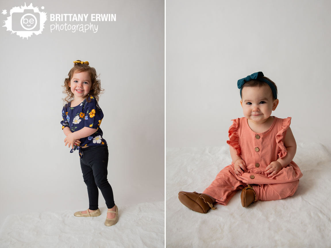 sisters-baby-girl-studio-portrait-photographer-white-backdrop-fuzzy-rug.jpg