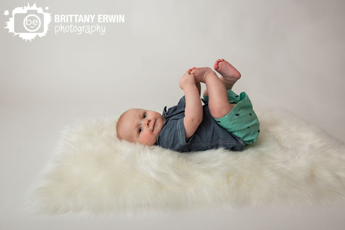 Indianapolis-portrait-photographer-milestone-portrait-session-baby-boy-on-fuzzy-white-fur-rug.jpg