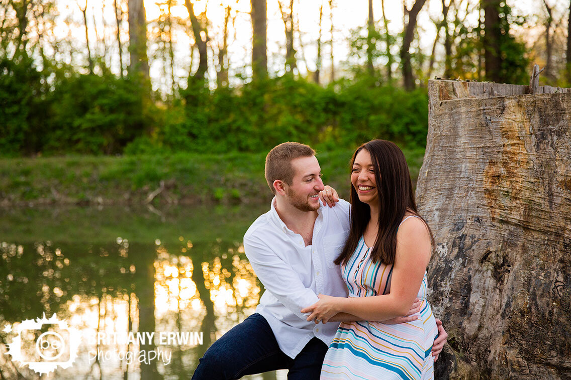 Indianapolis-portrait-photographer-engagement-couple-on-tree-trunk-by-water.jpg