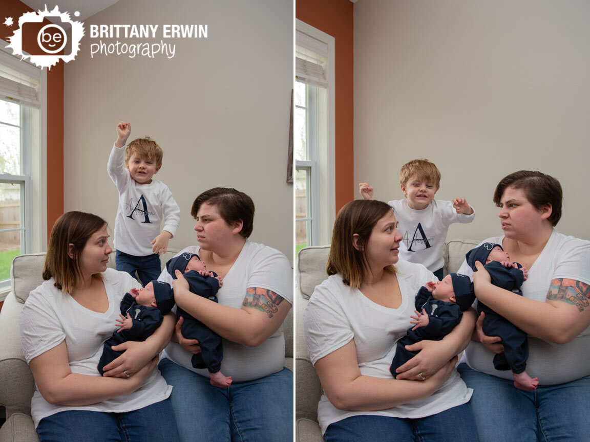 Indianapolis-newborn-family-portrait-photographer-funny-group-moms-holding-twin-baby-boys-with-toddler-boy-jumping.jpg