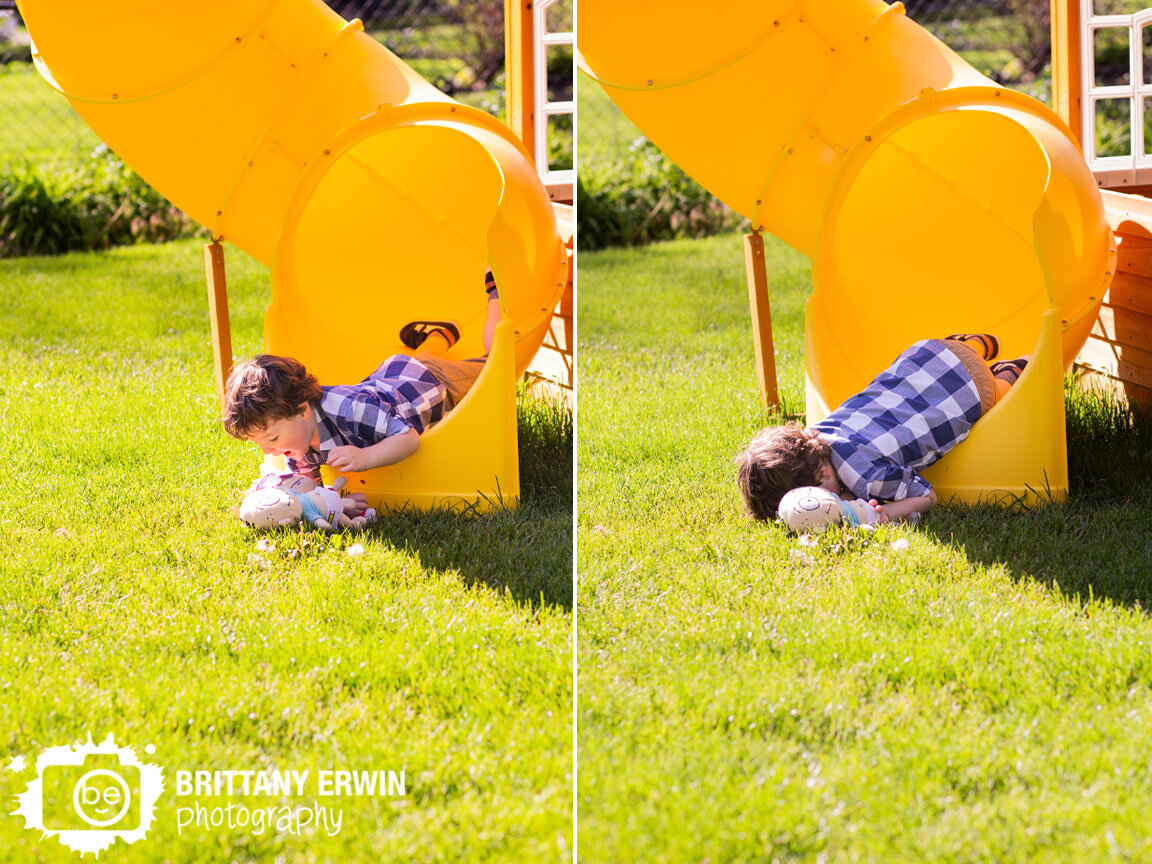 Toddler-boy-going-down-tube-slide-face-first-silly-playing-with-rugrats-toys.jpg