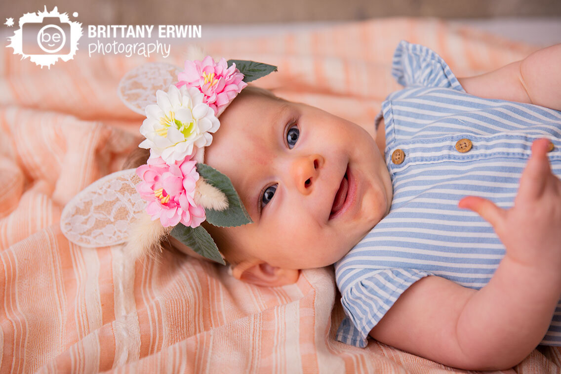 baby-girl-bunny-ears-striped-romper-on-pink-blanket-studio-photographer.jpg