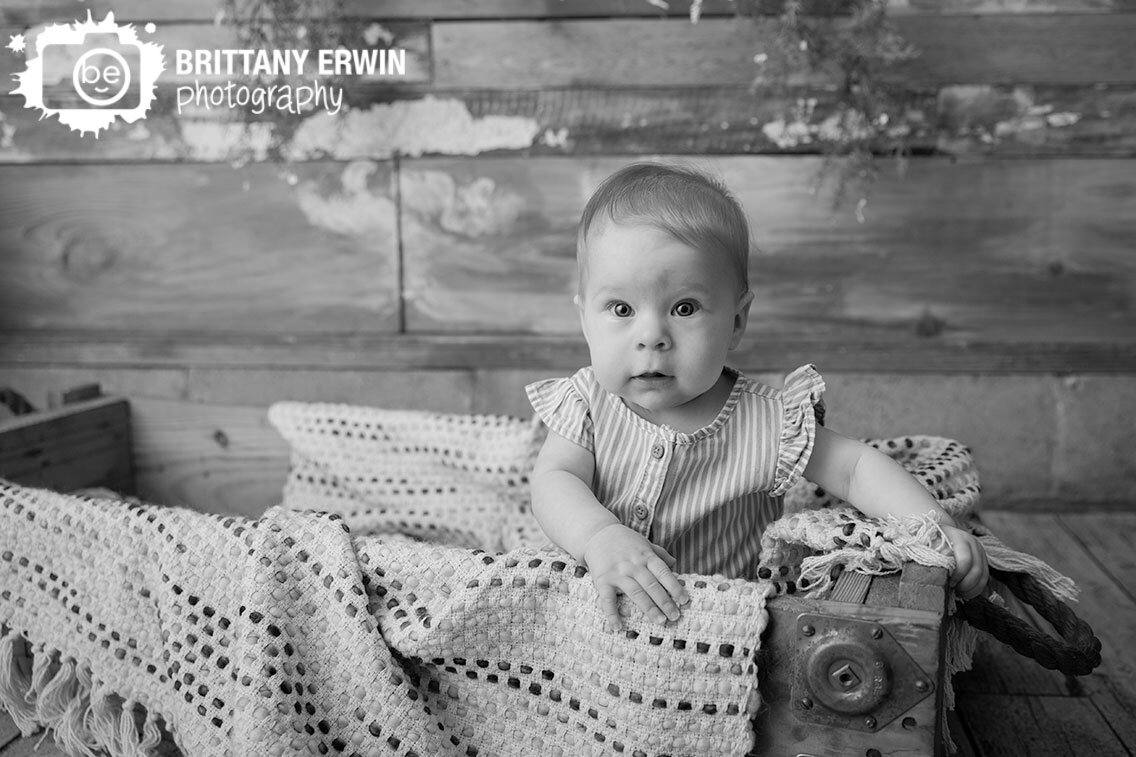 Indianapolis-portrait-studio-photographer-milestone-baby-girl-sitting-in-crate-rustic-wood.jpg