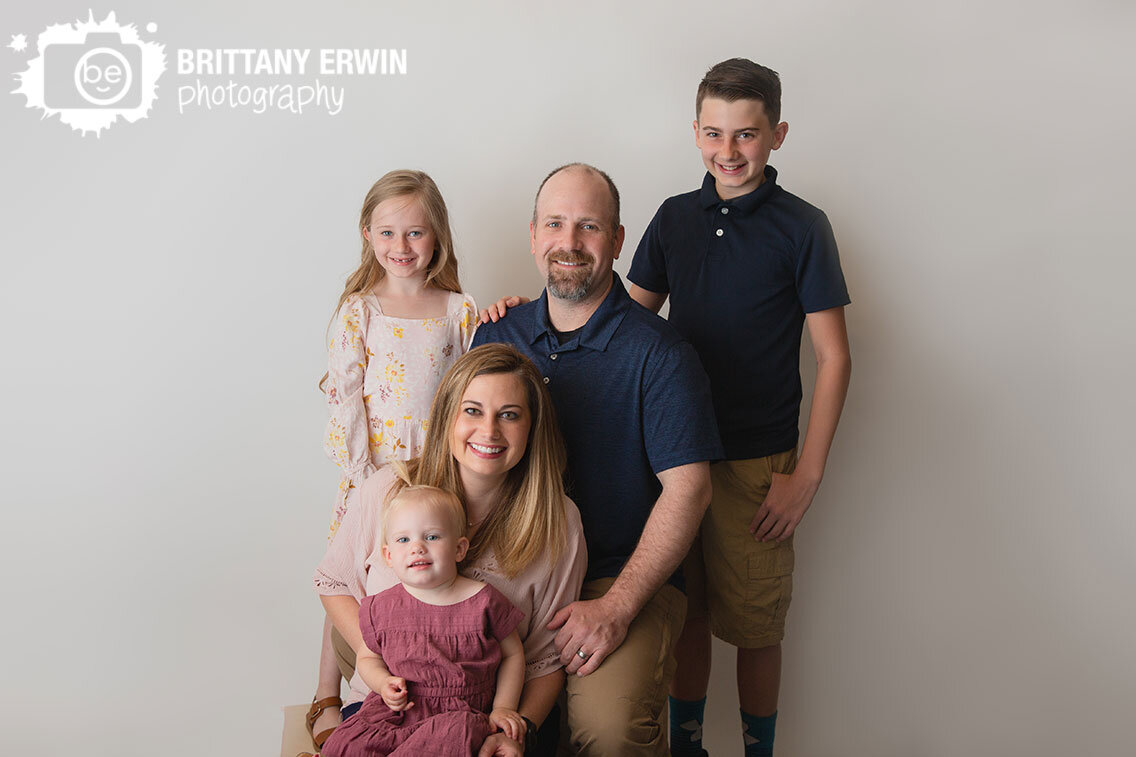 Indianapolis-portrait-studio-photographer-family-group-on-white-seamless-backdrop-siblings-with-parents.jpg