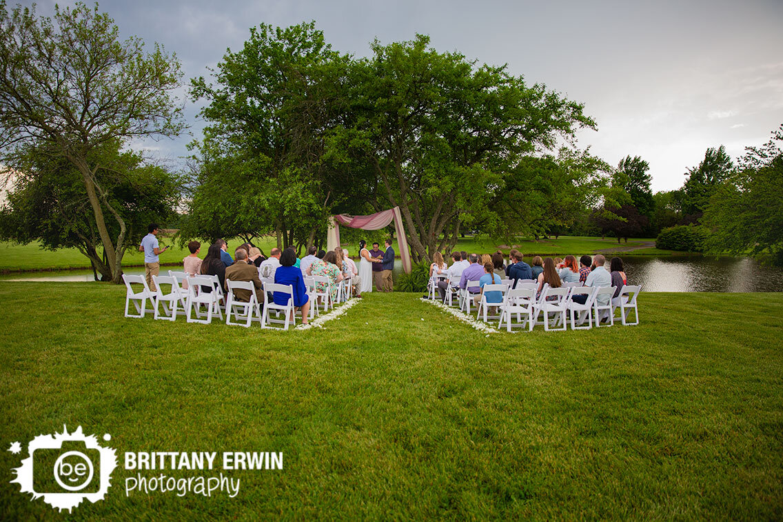 Indiana-wedding-photographer-backyard-ceremony-altar-under-trees-by-pond.jpg