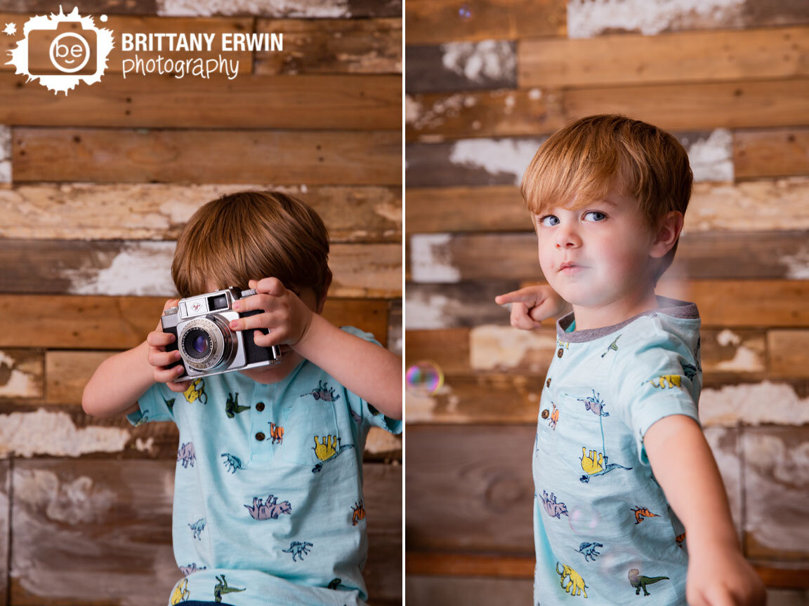 Indiana-studio-portrait-photographer-toddler-boy-playing-with-old-antique-camera-dinosaur-shirt-bubbles.jpg