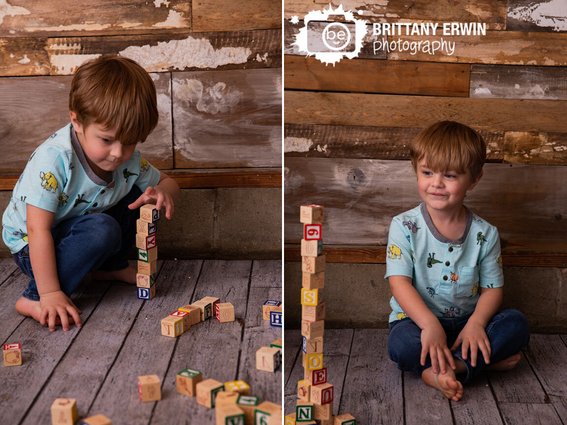 Toddler-boy-building-block-tower-funny-studio-portrait-photography.jpg