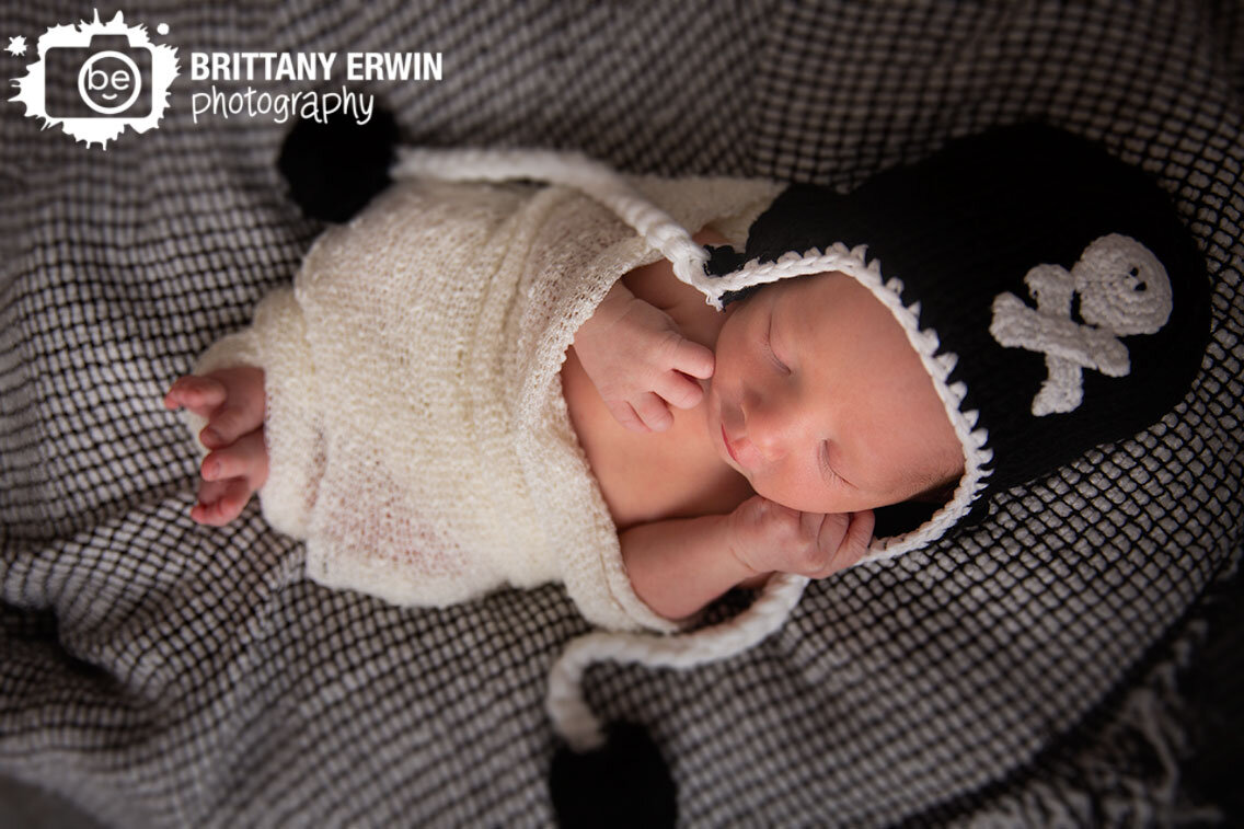 Indianapolis-newborn-baby-boy-portrait-photographer-skull-crossbones-black-hat-sleepy-boy.jpg