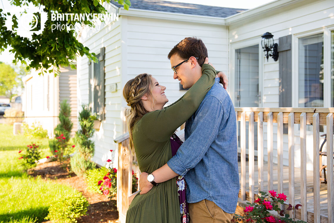 couple-out-front-of-home-rose-bush-porch-engagement-portrait-photographer.jpg