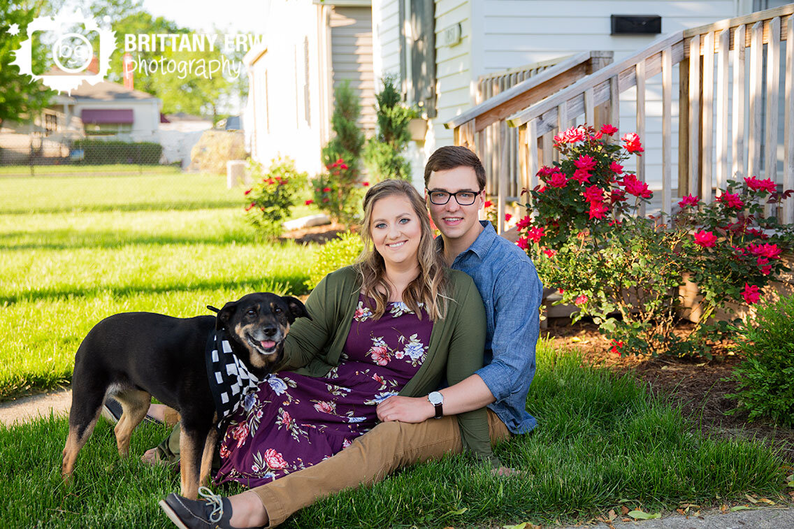 In-home-portrait-photographer-couple-outside-front-yard-rose-bushes-pet-dog-engagement.jpg