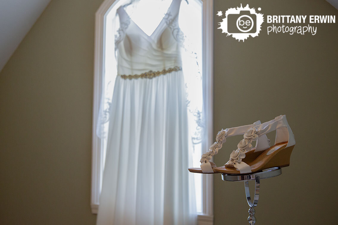 Indianapolis-wedding-photographer-shoes-on-mirror-with-dress-hanging-in-window.jpg