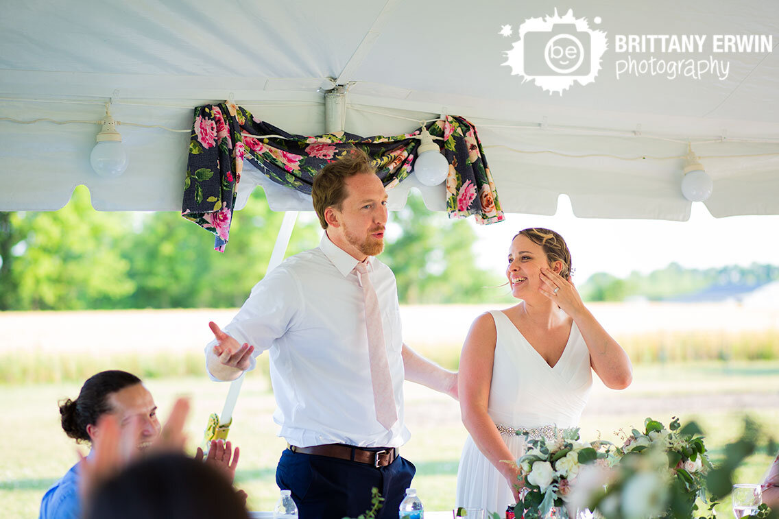 Indianapolis-wedding-photographer-groom-speech-bride-laughing-outdoor-reception.jpg