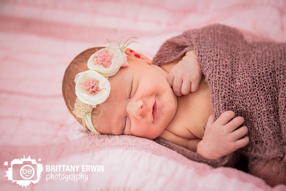 Lifestyle-newborn-photographer-baby-girl-pink-flower-headband-mauve-wrap.jpg