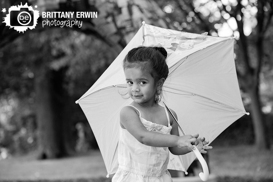 Indianapolis-portrait-photographer-toddler-girl-playing-with-umbrella-sunny-summer-day.jpg