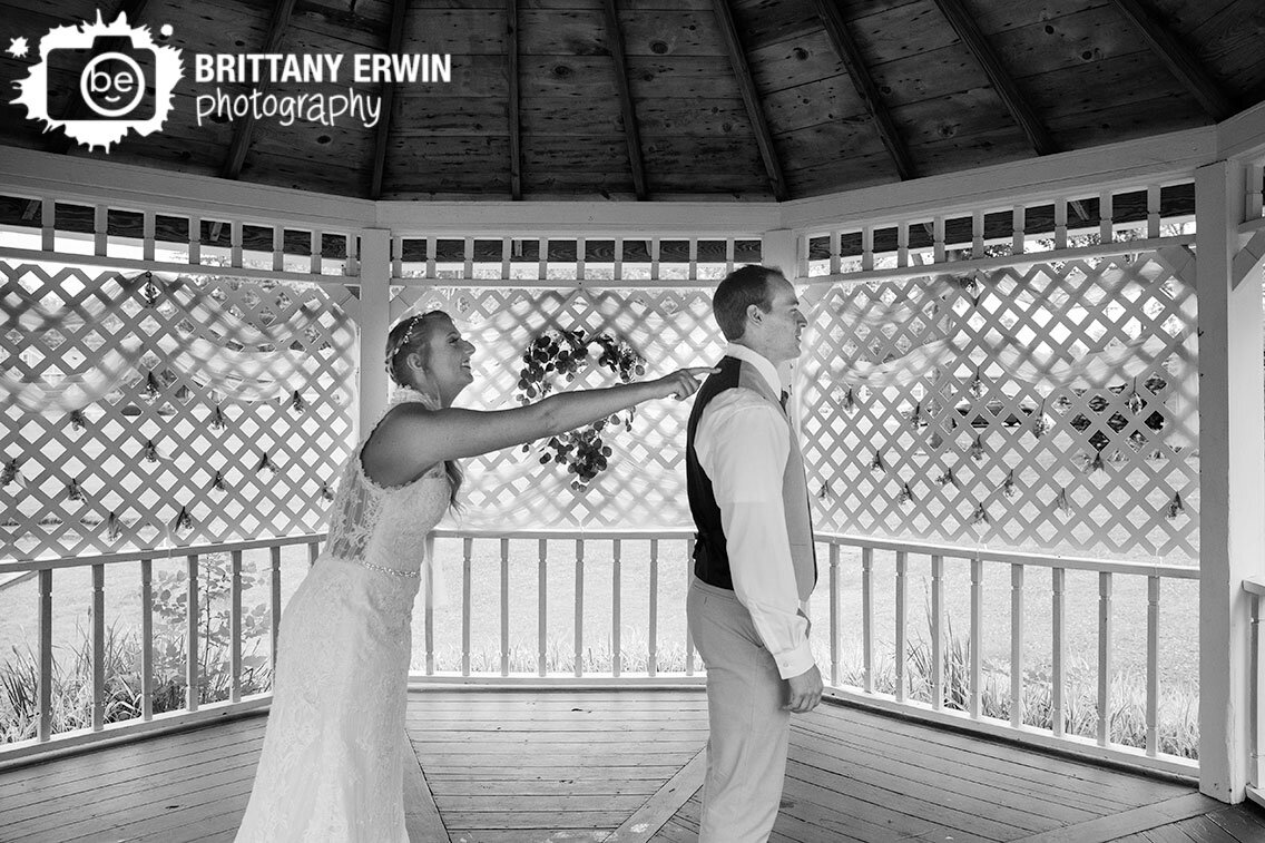 Indianapolis-wedding-photographer-couple-first-look-under-gazebo-bride-tapping-groom-on-shoulder.jpg