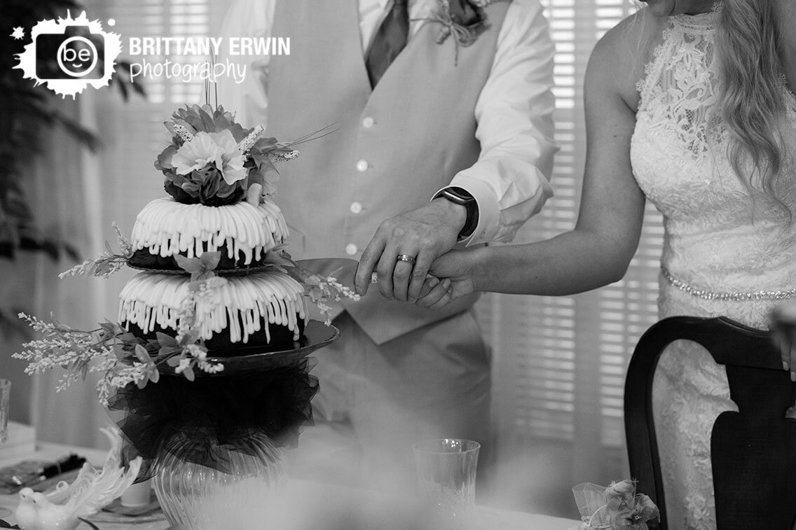 Indianapolis-wedding-photographer-reception-bride-groom-with-knife-cut-the-cake.jpg