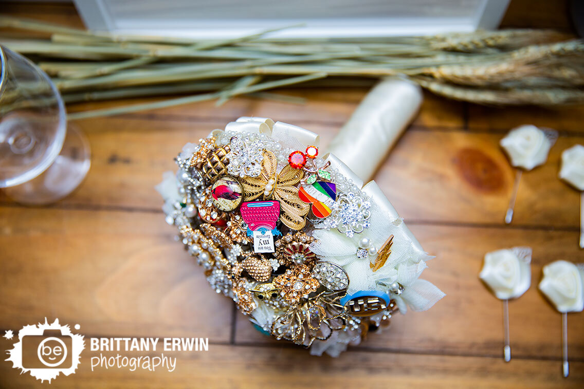 Wedding-details-photographer-brooch-bouquet-custom-made-with-pins-from-family-and-friends.jpg
