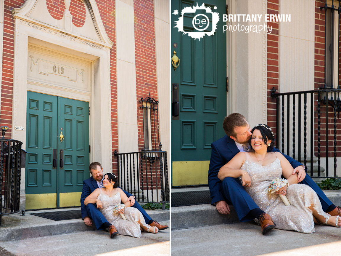 Indiana-wedding-photographer-couple-sitting-on-steps-in-lafayette-cheek-kiss.jpg