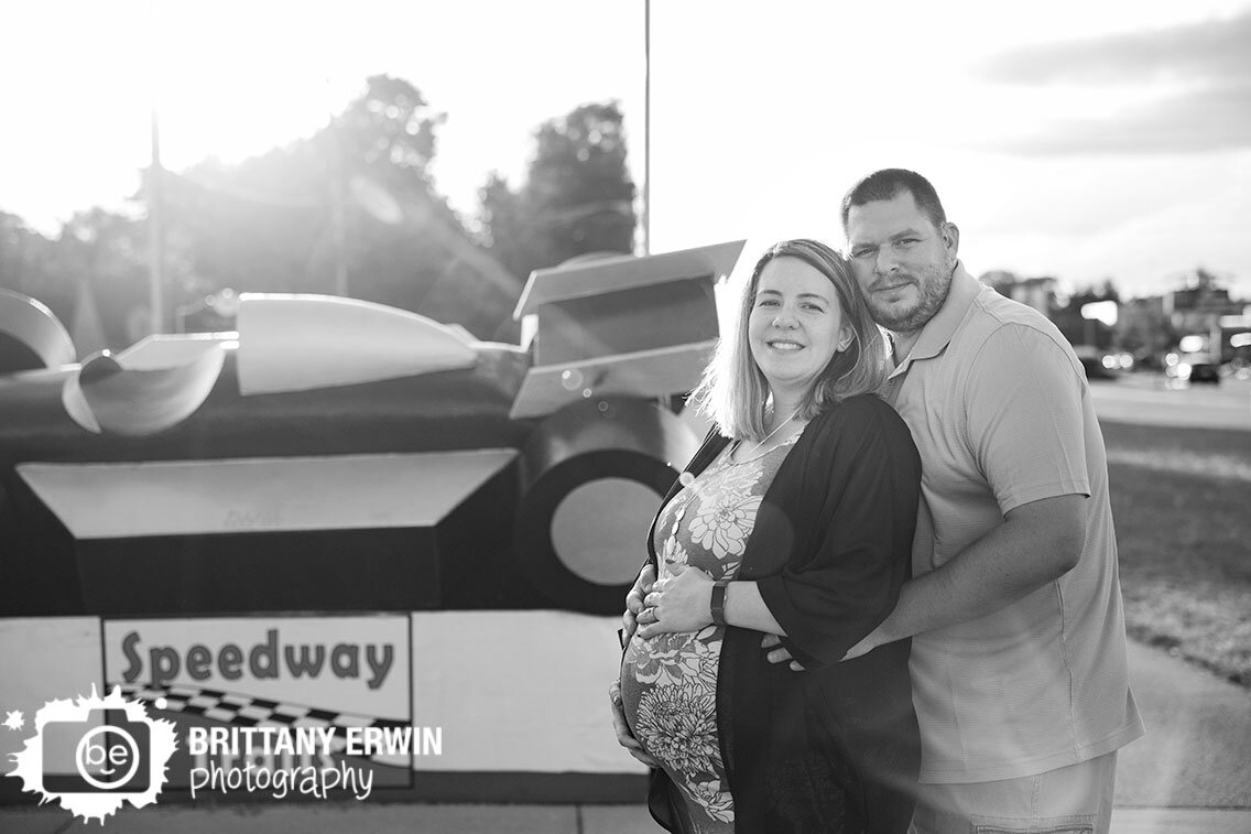 Speedway-Indiana-materinity-portrait-photographer-couple-with-indy-car-sculpture-sunset.jpg
