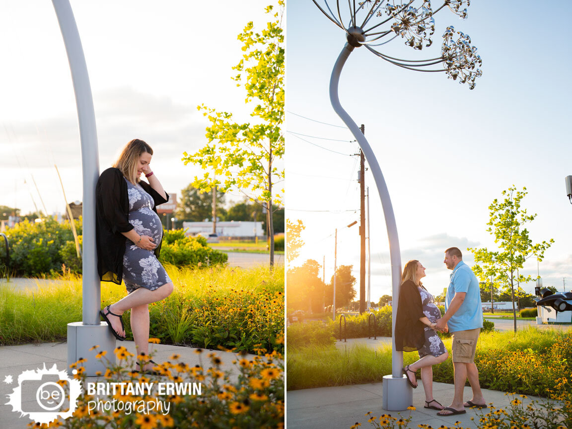 Speedway-Indiana-maternity-portrait-photographer-couple-with-sculpture-and-black-eyed-susan-flowers.jpg