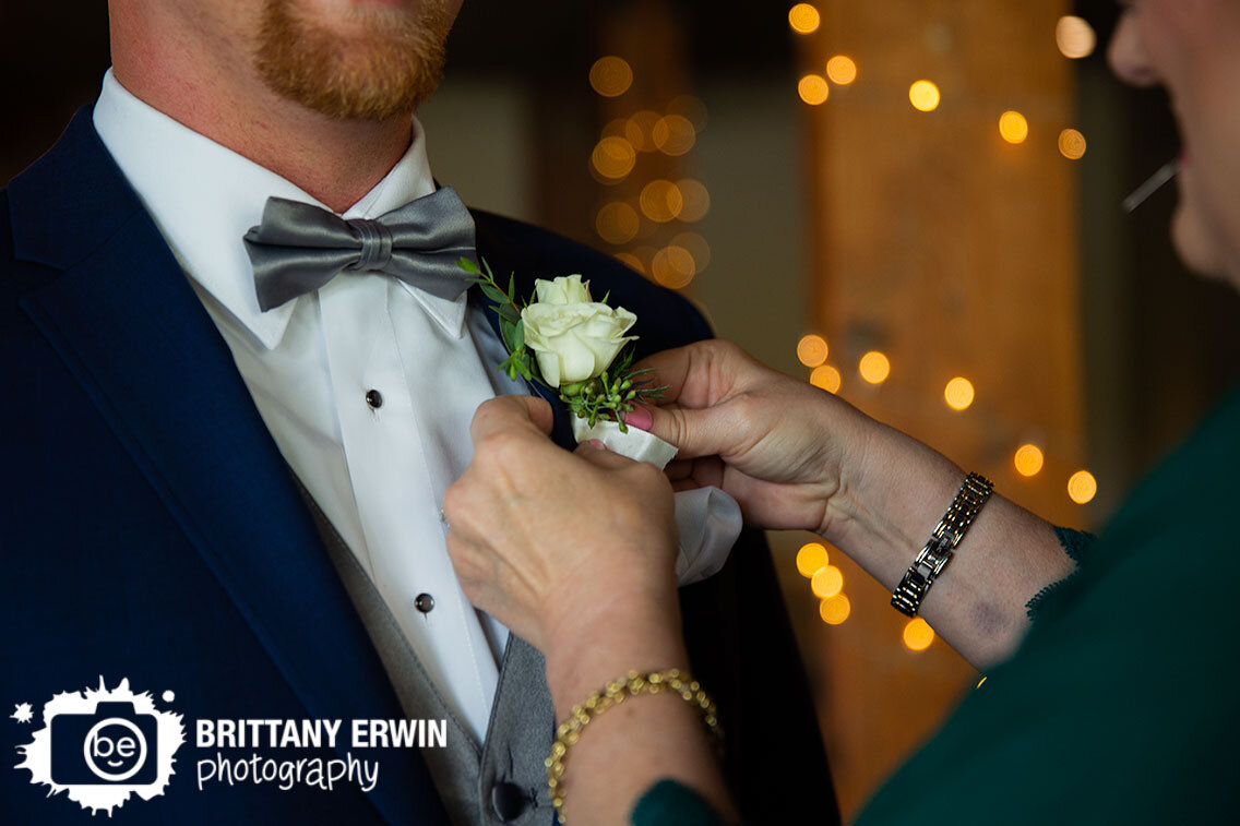 groom-getting-boutonniere-pinned-on-by-mother.jpg