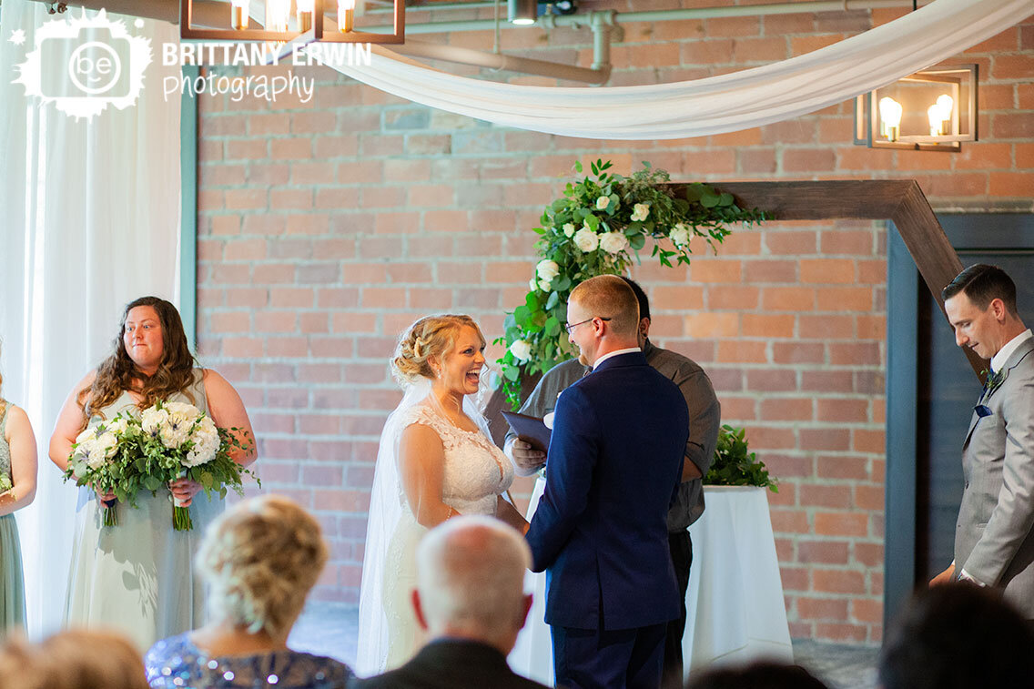 bride-laughing-at-altar-Garment-Factory-wedding-ceremony-venue-indoor-brick-wall.jpg