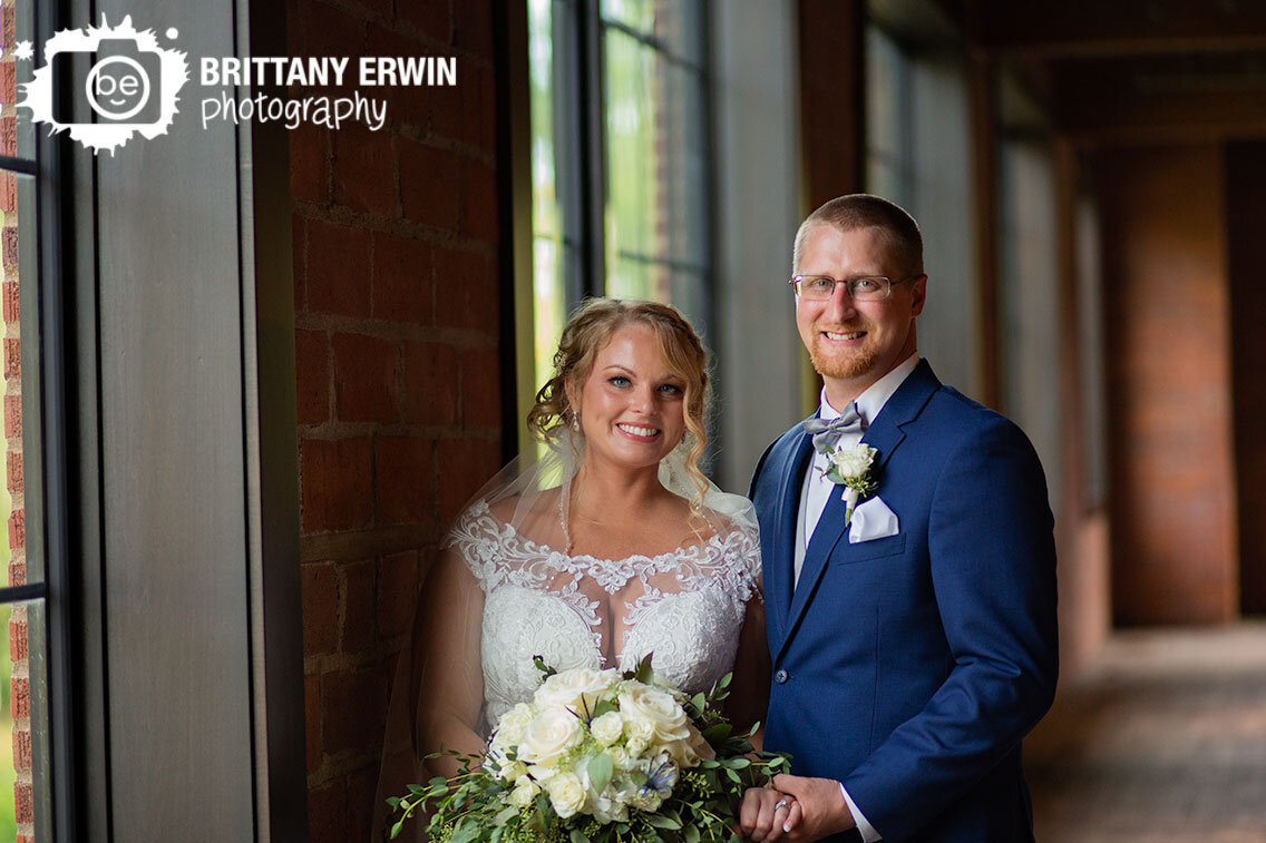 Franklin-Indiana-window-at-Garment-Factory-couple-with-white-bouquet-brick-wall.jpg