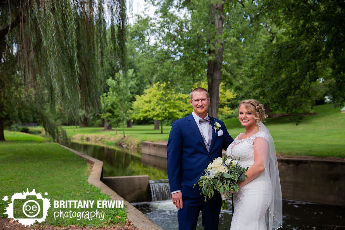 Franklin-Indiana-park-wedding-photographer-couple-by-waterfall-veil-blue-suit.jpg