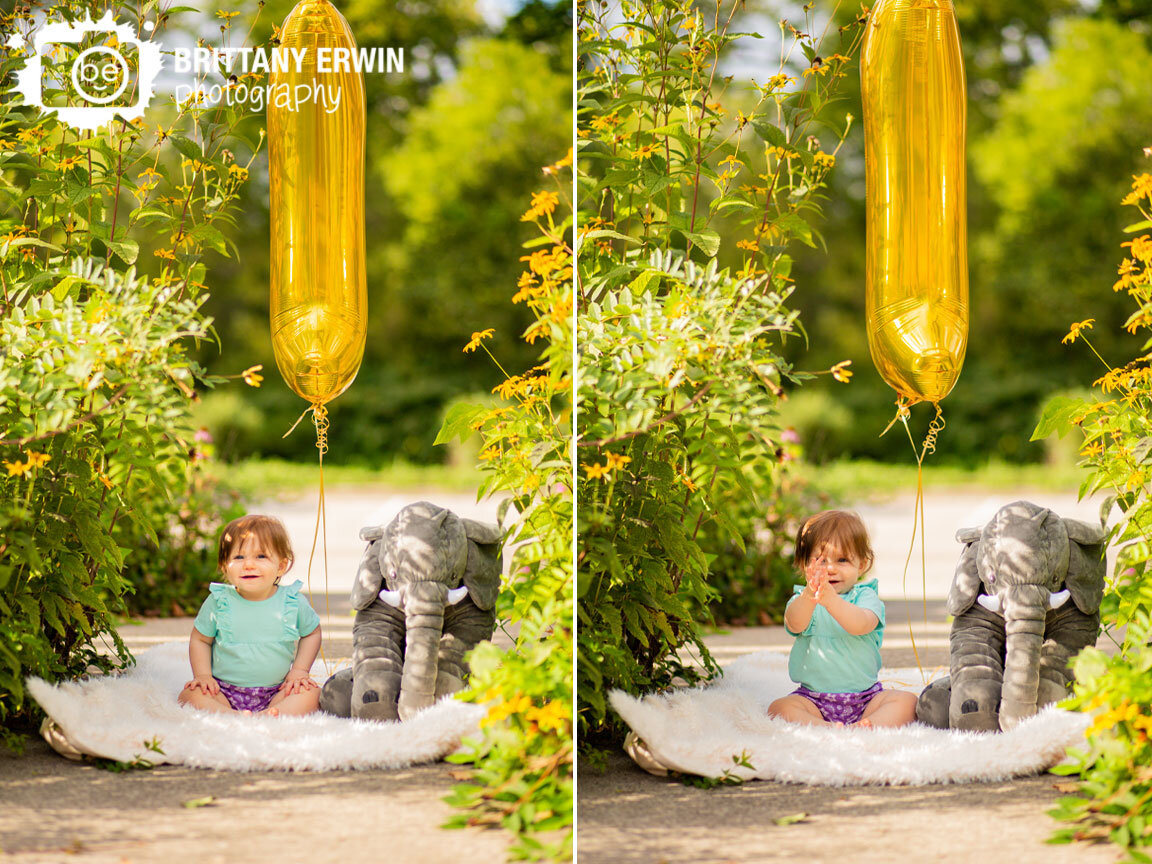 Indianapolis-Art-Center-wedding-photographer-baby-girl-with-stuffed-animal-number-one-balloon-clapping.jpg