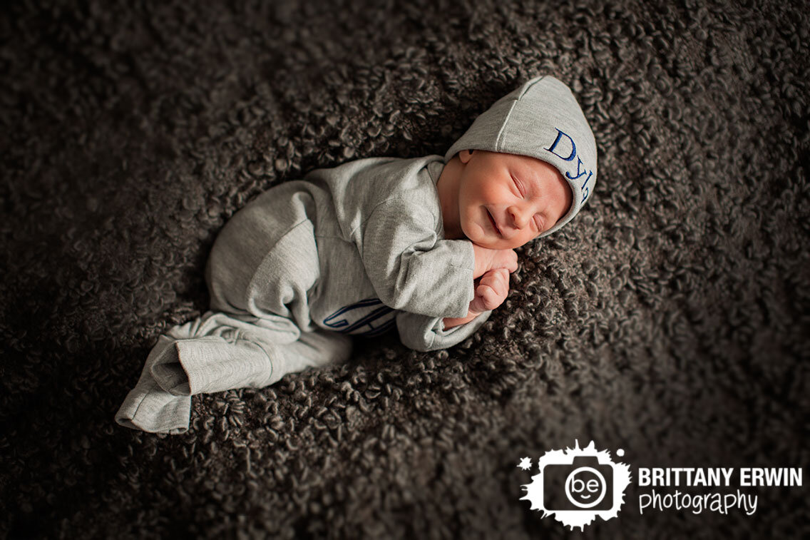 Indianapolis-newborn-portrait-photographer-baby-boy-sleeping-on-textured-blanket-custom-hat.jpg