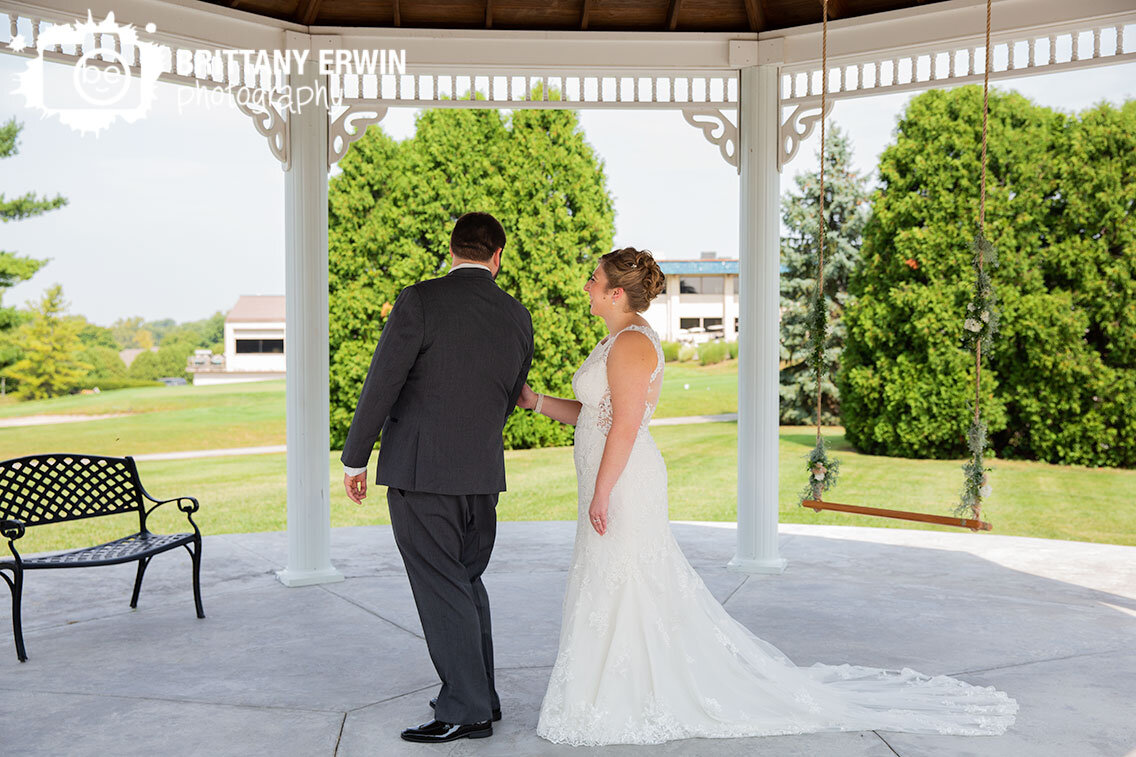 groom-turning-around-to-see-bride-at-first-look-outside.jpg