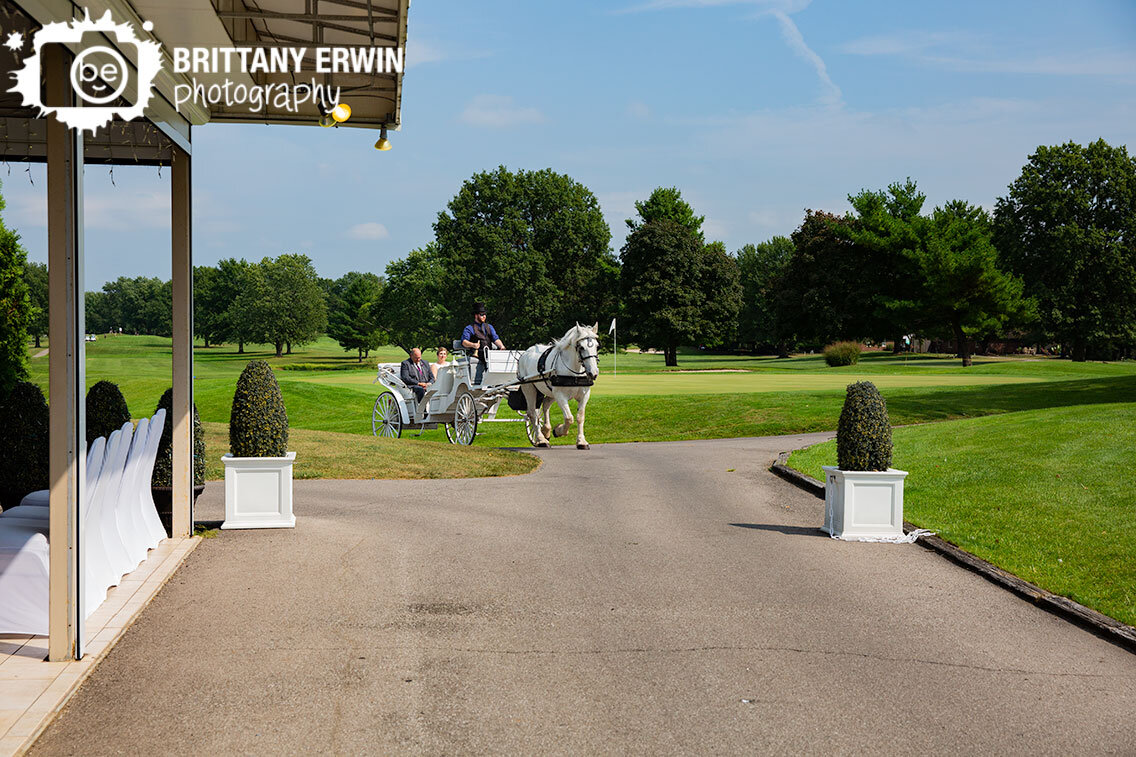 father-with-bride-on-horse-drawn-carriage-arriving-to-ceremony.jpg