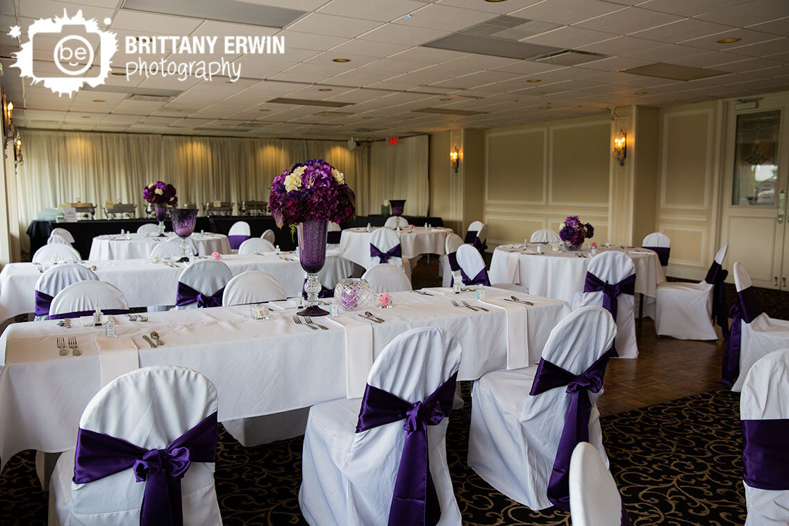 Valle-Vista-wedding-reception-venue-ballroom-setup-with-white-chairs-purple-sashes-and-flowers.jpg